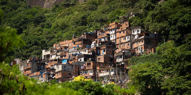 The Rocinha favela stands out from a hillside in Rio de Janeiro, Brazil, Monday, March 16, 2020. Rocinha, Brazil's largest favela, is home to about 70,000 people as of the latest census.