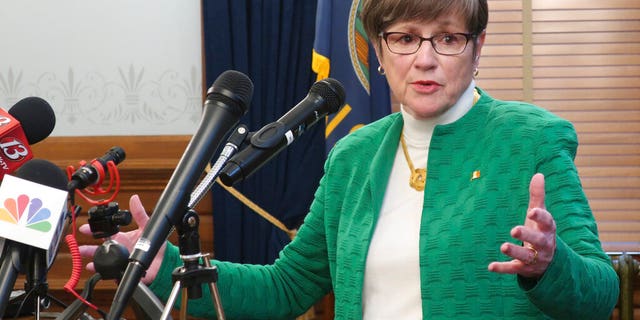 Kansas Gov. Laura Kelly answers questions from reporters after announcing that she'd order all public and private K-12 schools in the state to close for the rest of the semester, Tuesday, March 17, 2020, at the Statehouse in Topeka, Kan.