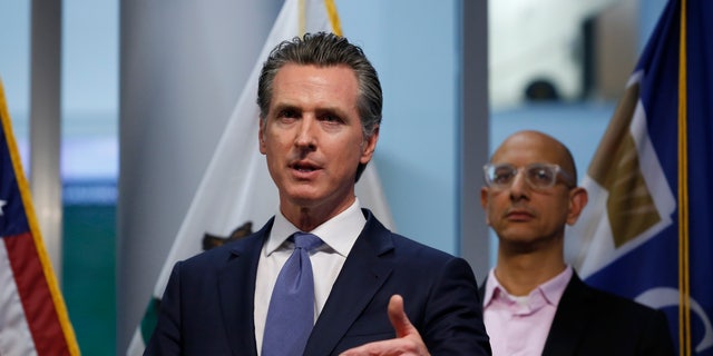 California Gov. Gavin Newsom updates the state's response to the coronavirus, at the Governor's Office of Emergency Services in Rancho Cordova Calif., Tuesday, March 17, 2020. At right is California Health and Human Services Agency Director Dr. Mark Ghaly. 
