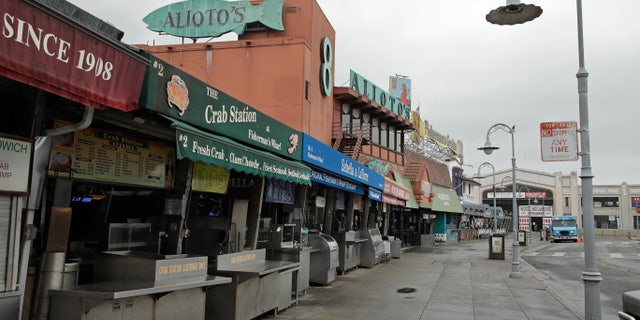 A deserted Fisherman's Wharf is seen on Wednesday, March 18, 2020, in San Francisco. Officials in seven San Francisco Bay Area counties have issued a shelter-in-place mandate affecting about 7 million people, including the city of San Francisco itself. The order says residents must stay inside and venture out only for necessities for three weeks starting Tuesday. (AP Photo/Ben Margot)