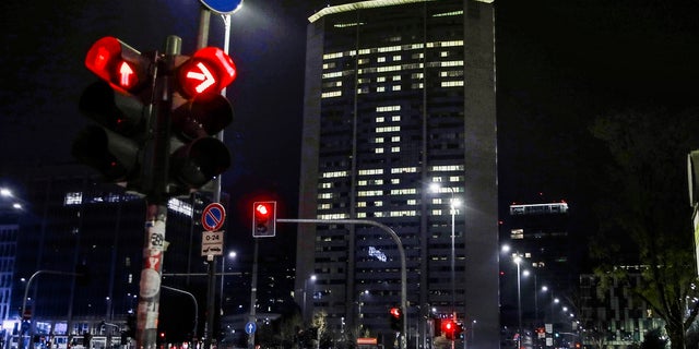 Office lights of the Lombardy region headquarters building in Milan, northern Italy, compose the Italian words 'State a casa' (Stay home), Wednesday, March 18, 2020. Italian authorities say too many people are violating a national decree, which allows people to leave homes to go to workplaces, buy food or other necessities or for brief strolls outside to walk dogs or get exercise. (AP Photo/Luca Bruno)