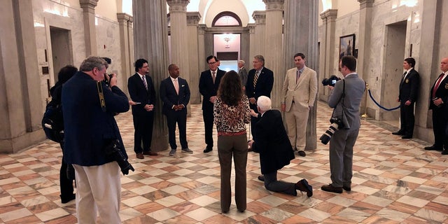 Reporters and members of the General Assembly practice social distancing during a news conference at the South Carolina Statehouse in Columbia, S.C., on Thursday. The Legislature passed $45 million in emergency money for state health officials to fight the coronavirus. (AP Photo/Jeffrey Collins)