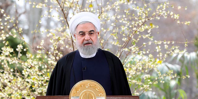 In this photo released on Friday March 20, 2020 by the official website of the office of the Iranian Presidency, President Hassan Rouhani delivers a message for the Iranian New Year, or Nowruz, in Tehran, Iran. Supreme Leader Ayatollah Ali Khamenei and President Hassan Rouhani in separate new year messages vowed to overcome the new coronavirus and increase economic growth. (Iranian Presidency Office via AP)