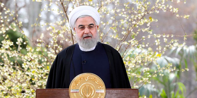 In this photo released on Friday March 20, 2020 by the official website of the office of the Iranian Presidency, President Hassan Rouhani delivers a message for the Iranian New Year, or Nowruz, in Tehran, Iran. Supreme Leader Ayatollah Ali Khamenei and President Hassan Rouhani in separate new year messages vowed to overcome the new coronavirus and increase economic growth. (Iranian Presidency Office via AP)