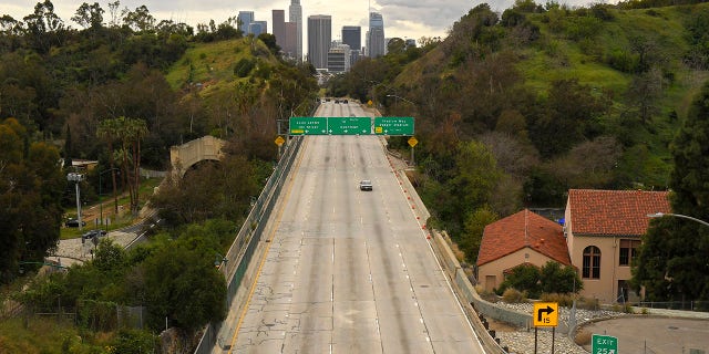 Extremely light traffic moves along the 110 Harbor Freeway toward downtown mid afternoon, Friday, March 20, 2020, in Los Angeles. Traffic would normally be bumper-to-bumper during this time of day on a Friday. California Gov. Gavin Newsom is ordering the state's 40 million residents to stay at home indefinitely. His order restricts non-essential movements to control the spread of the coronavirus that threatens to overwhelm the state's medical system. He called up 500 National Guard troops Thursday to help with distributing food.