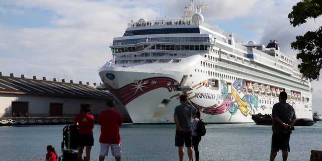 The Norwegian Jewel cruise ship docks at Honolulu Harbor on March 22. The cruise ship that had to cut short its trip because of the new coronavirus and mechanical problems docked Sunday in Honolulu's harbor. (Cindy Ellen Russell/Honolulu Star-Advertiser via AP)