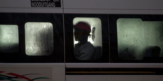 A passenger sits inside a mini-bus taxi in Tembisa, east of Johannesburg, South Africa, Monday, March 23, 2020. South Africa, Africa's most industralized economy and a nation of 57 million people, will to go into a nationwide lockdown for 21 days from Thursday to fight the spread of the new coronavirus. (AP Photo/Themba Hadebe)