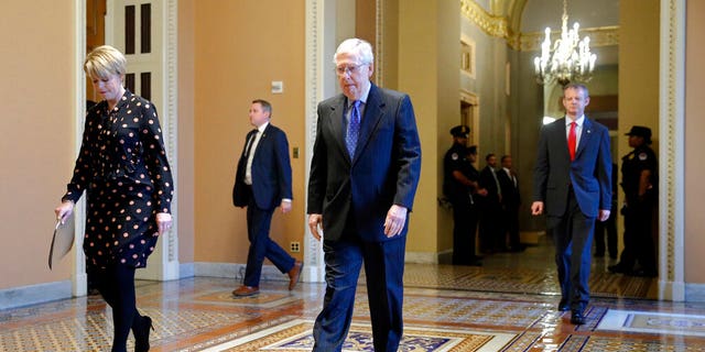 Senate Majority Leader Mitch McConnell of Ky. walks to the Senate chamber on Capitol Hill in Washington, Tuesday, March 24, 2020. (AP Photo/Patrick Semansky)