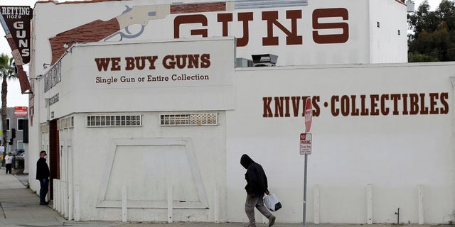 Guns are advertised for sale at a gun shop in Culver City, Calif. (AP Photo/Marcio Jose Sanchez)