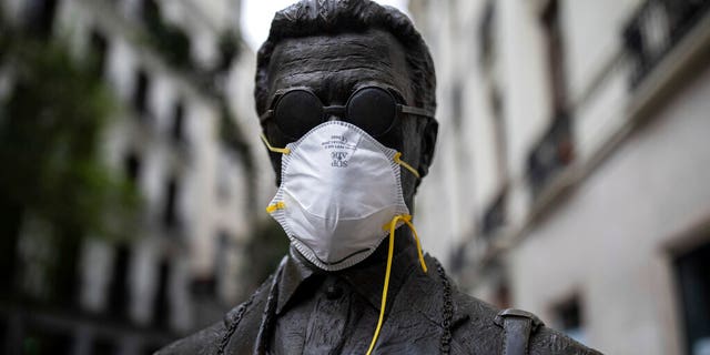 Dems fume at Trump over resistance to using economic freeze to fight coronavirus 1 A face mask is put on a statue during the coronavirus outbreak in downtown Madrid, Spain, Tuesday, March 24, 2020. More than 1.5 billion around the world have been told to stay in their homes. For most people, the new coronavirus causes only mild or moderate symptoms. For some it can cause a more serious illness. (AP Photo/Bernat Armangue)