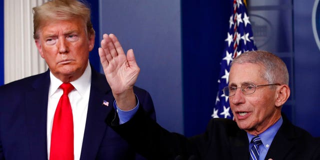 President Donald Trump listens as Dr. Anthony Fauci, director of the National Institute of Allergy and Infectious Diseases, speaks about the coronavirus in the James Brady Briefing Room, Tuesday, March 24, 2020, in Washington. (AP Photo/Alex Brandon)