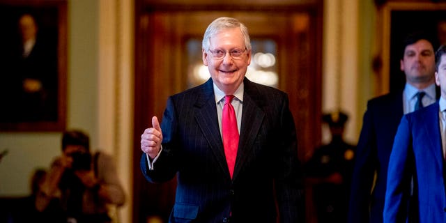 Senate Majority Leader Mitch McConnell of Ky. gives a thumbs up as he leaves the Senate chamber on Capitol Hill in Washington, Wednesday, March 25, 2020, where a deal has been reached on a coronavirus bill. The 2 trillion dollar stimulus bill is expected to be voted on in the Senate Wednesday. (AP Photo/Andrew Harnik)