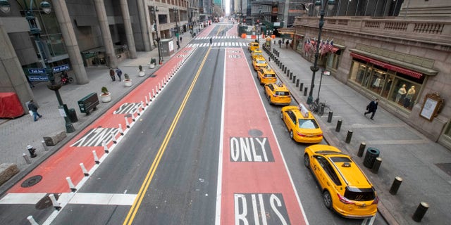 Yellow cabs line an empty 42nd St. waiting for fares outside Grand Central Terminal, Wednesday, March 25, 2020, in New York. Hospitalizations from COVID-19 were rising faster than expected in New York as residents and leaders prepared for a peak in cases that is expected to still be weeks away. Temporary hospitals, and even a morgue in Manhattan, are being setup.