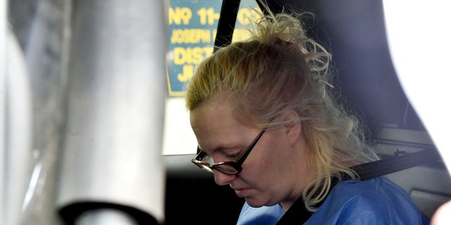 Margaret Ann Cirko sits in a police car after her arrest Thursday in Hanover Township, Pa. (Associated Press)