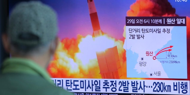 A man watches a TV screen showing a file image of North Korea's missile launch during a news program at the Seoul Railway Station in Seoul, South Korea, Sunday, March 29, 2020. North Korea on Sunday fired two suspected ballistic missiles into the sea, South Korea said, calling it "very inappropriate" at a time when the world is battling the coronavirus pandemic. The Korean letters read: " North Korea launched two suspected ballistic missiles into the sea." (AP Photo/Ahn Young-joon)