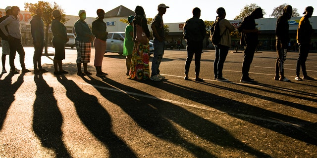 Pensioners queue for their social grant at a paypoint in Cape Town, South Africa, Monday, 30, 2020, as South Africa remained in a nationwide lockdown for 21 days in an effort to control the spread of the coronavirus. The virus causes mild or moderate symptoms for most people, but for some, especially older adults and people with existing health problems, it can cause more severe illness or death. (AP Photo)