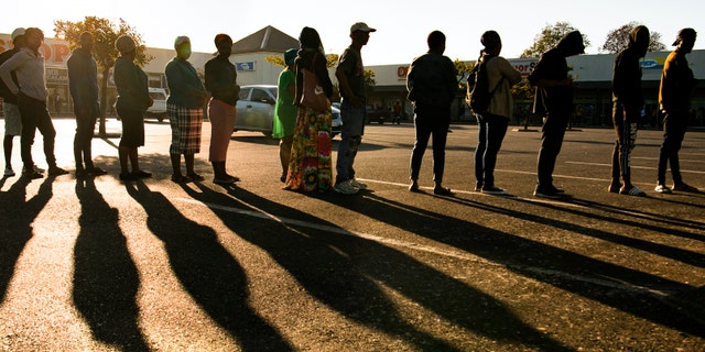 Pensioners queue for their social grant at a paypoint in Cape Town, South Africa, Monday, 30, 2020, as South Africa remained in a nationwide lockdown for 21 days in an effort to control the spread of the coronavirus. The virus causes mild or moderate symptoms for most people, but for some, especially older adults and people with existing health problems, it can cause more severe illness or death. (AP Photo)