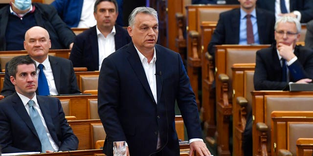 Hungarian Prime Minister Viktor Orban replies to faction leader of the oppositional Jobbik party Peter Jakab during a question and answer session of the Parliament in Budapest, Hungary, Monday, March 30, 2020.
