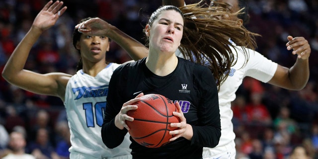 Portland's Alex Fowler (12) grabs a rebound over San Diego during the first half of an NCAA college basketball game in the final of the West Coast Conference women's tournament Tuesday, March 10, 2020, in Las Vegas. (AP Photo/John Locher)