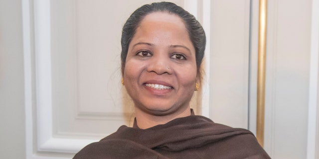 Asia Bibi, a Pakistani Christian woman, poses with her diploma as a Citizen of Honor of the city of Paris at City Hall in Paris, Tuesday, Feb. 25, 2020. Bibi,  acquitted of blasphemy after spending eight years on death row in Pakistan, said she is going to request asylum in France. (AP Photo/Michel Euler)