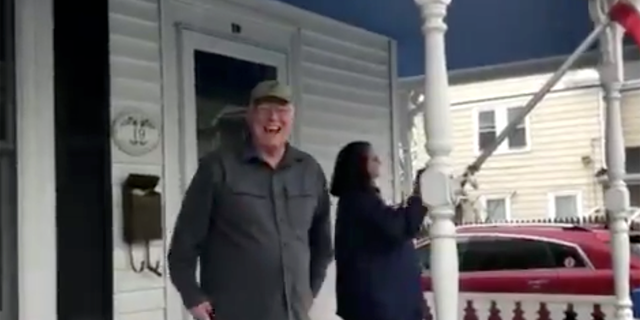 Christopher Eleey, 70, reacts to a birthday parade on Sunday outside his home in Quincy, Mass.