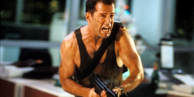 Actor Bruce Willis is pictured running with an automatic weapon in a scene from the film "Die Hard," in 1988. The "Die Hard" film series was mentioned in a popular Reddit thread about the "most awesome" things in life. 