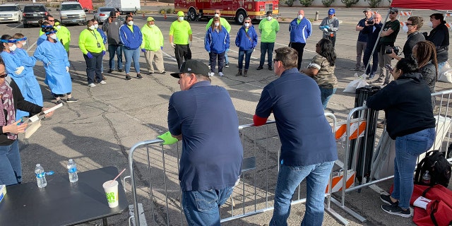 Volunteers and workers set up a temporary homeless shelter in a parking lot in Las Vegas on Saturday.
