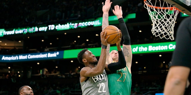 Brooklyn Nets guard Caris LeVert (22) drives to the basket against Boston Celtics' Daniel Theis during the first half of an NBA basketball game Tuesday, March 3, 2020, in Boston. (AP Photo/Mary Schwalm)