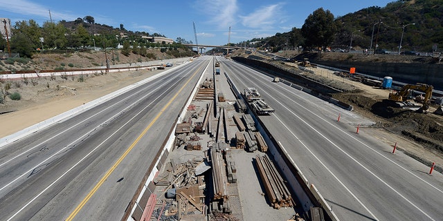 LOS ANGELES, CA - SEPTEMBER 29: All lanes of the 405 Freeway are empty except for construction trucks as crews continue to demolish a portion of the Mulholland Drive bridge along the 405 Freeway September 29, 2012 in Los Angeles, California.