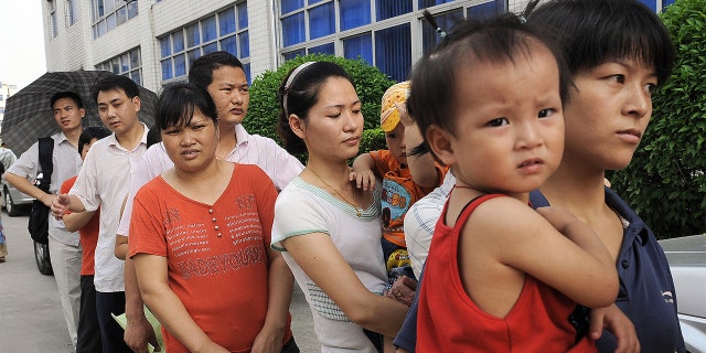 Parents queue up to have their children checked at Longgang central hospital in Shenzhen on Sept. 21, 2008 amidst a tainted milk scandal that killed four babies. (Photo credit should read TED ALJIBE/AFP via Getty Images)