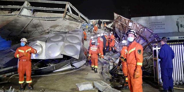 Rescuers work at the site of a collapsed five-story hotel building in Quanzhou city in southeast China's Fujian province Saturday, March 7, 2020. 