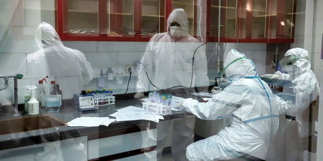 In this Tuesday, March, 10, 2020 photo, paramedics test samples taken from patients suspected of being infected with the new coronavirus, at a laboratory in the southwestern city of Ahvaz, Iran. For most people, the new coronavirus causes only mild or moderate symptoms, such as fever and cough. For some, especially older adults and people with existing health problems, it can cause more severe illness, including pneumonia. (Amin Nazari/ISNA via AP)