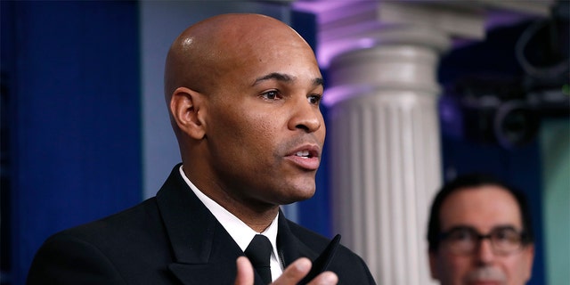 U.S. Surgeon General Jerome Adams speaks during a briefing on coronavirus in the Brady press briefing room at the White House, Saturday, March 14, 2020, in Washington. Adams reassured Americans this month that a coronavirus vaccine "will be safe. It will be effective. Or it won't get moved along." (AP Photo/Alex Brandon)