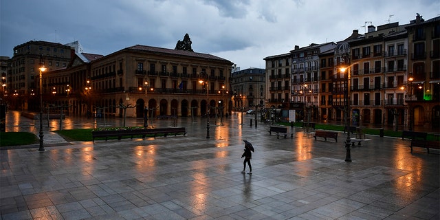 A lone person walking through an empty Plaza del Castillo square in the old city, in Pamplona, northern Spain, on Sunday. (AP Photo/Alvaro Barrientos) A lone person walking through an empty Plaza del Castillo square in the old city, in Pamplona, northern Spain, on Sunday. (AP Photo/Alvaro Barrientos)