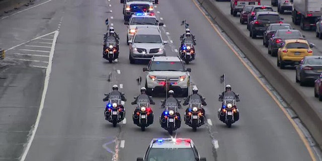 Members of the Philadelphia Police Department escorted the body of fallen officer James O'Connor from the hospital to the morgue after he was shot and killed during the apprehension of a murder suspect. 