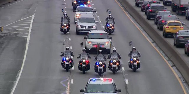 Members of the Philadelphia Police Department escorted the body of fallen officer James O'Connor from the hospital to the morgue after he was shot and killed during the apprehension of a murder suspect.