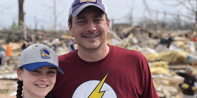 Darrin Crockett and his daughter Carly sift through what's left of their house, looking for any items that can be recovered.