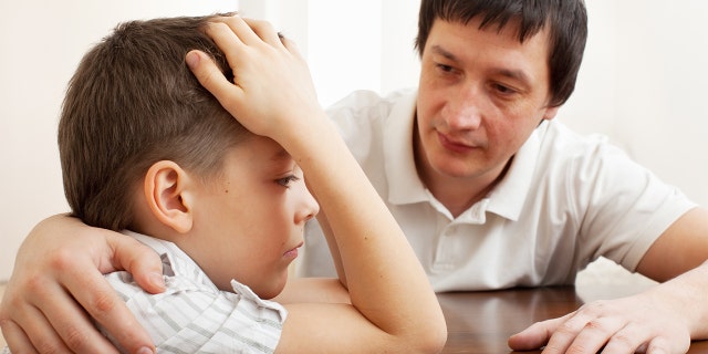 Father comforts a child with a fever.