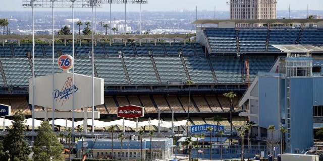 The exterior of Dodgers Stadium, home of the Los Angeles Dodgers is seen Wednesday, March 25, 2020, in Los Angeles. There will be empty ballparks on what was supposed to be Major League Baseball's opening day, with the start of the Major League Baseball regular season indefinitely on hold because of the coronavirus pandemic. (AP Photo/Marcio Jose Sanchez)