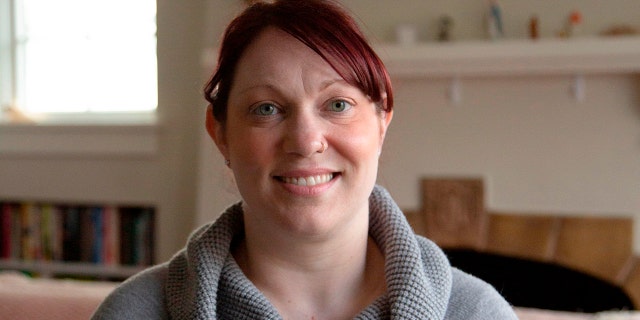 Elizabeth Schneider poses at her house in Seattle, Wash., on March 11, 2020.