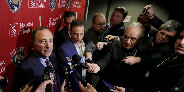 National Hockey League Commissioner Gary Bettman, left, speaks to members of the media , Saturday, March 7, 2020, in Sunrise, Fla. (AP Photo/Wilfredo Lee)