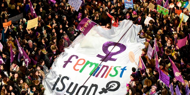 Demonstrators hold a banner and placards during a rally marking the International Women's Day on Istiklal avenue, in Istanbul, on March 8, 2019.