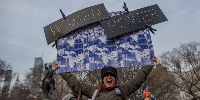 A woman holds a banner during a rally to mark International Women's Day at Union Square on March 08, 2019.