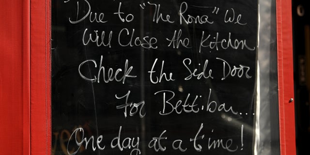A notice posted in the window of Hourglass Tavern on Manhattan's Restaurant Row notes that the kitchen is closed as coronavirus cases and fears continue to spread on March 16.