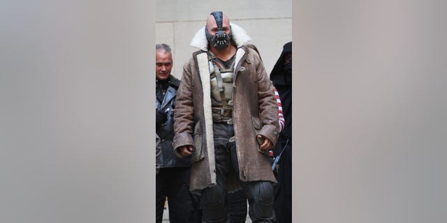 Tom Hardy is seen in costume as Bane on the set of 'The Dark Knight Rises' on location on Wall Street on November 5, 2011 in New York City.