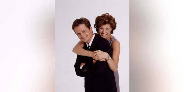 Michael J. Fox as Mike Flaherty (L) and Connie Britton as Nikki Faber (R) in the ABC comedy series 'Spin City.'
