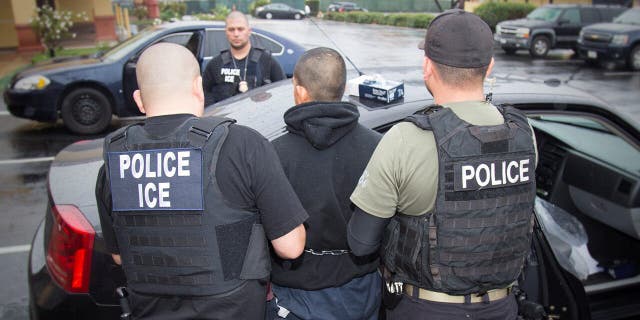 An ICE agent makes an arrest.