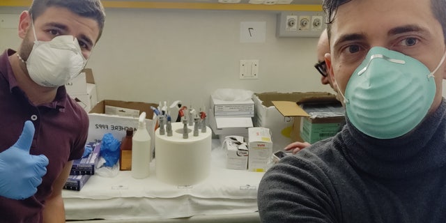 Alessandro Romaioli (left), and Cristian Fracassi (right) of Isinnova with their 3D-printed ventilator valves.