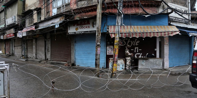 A barbed wire erected by authorities as part of enforcing a lockdown as a precautionary measure against COVID-19 in Jammu, India, Tuesday.