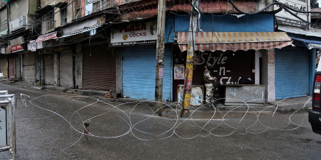 A barbed wire erected by authorities as part of enforcing a lockdown as a precautionary measure against COVID-19 in Jammu, India, Tuesday.